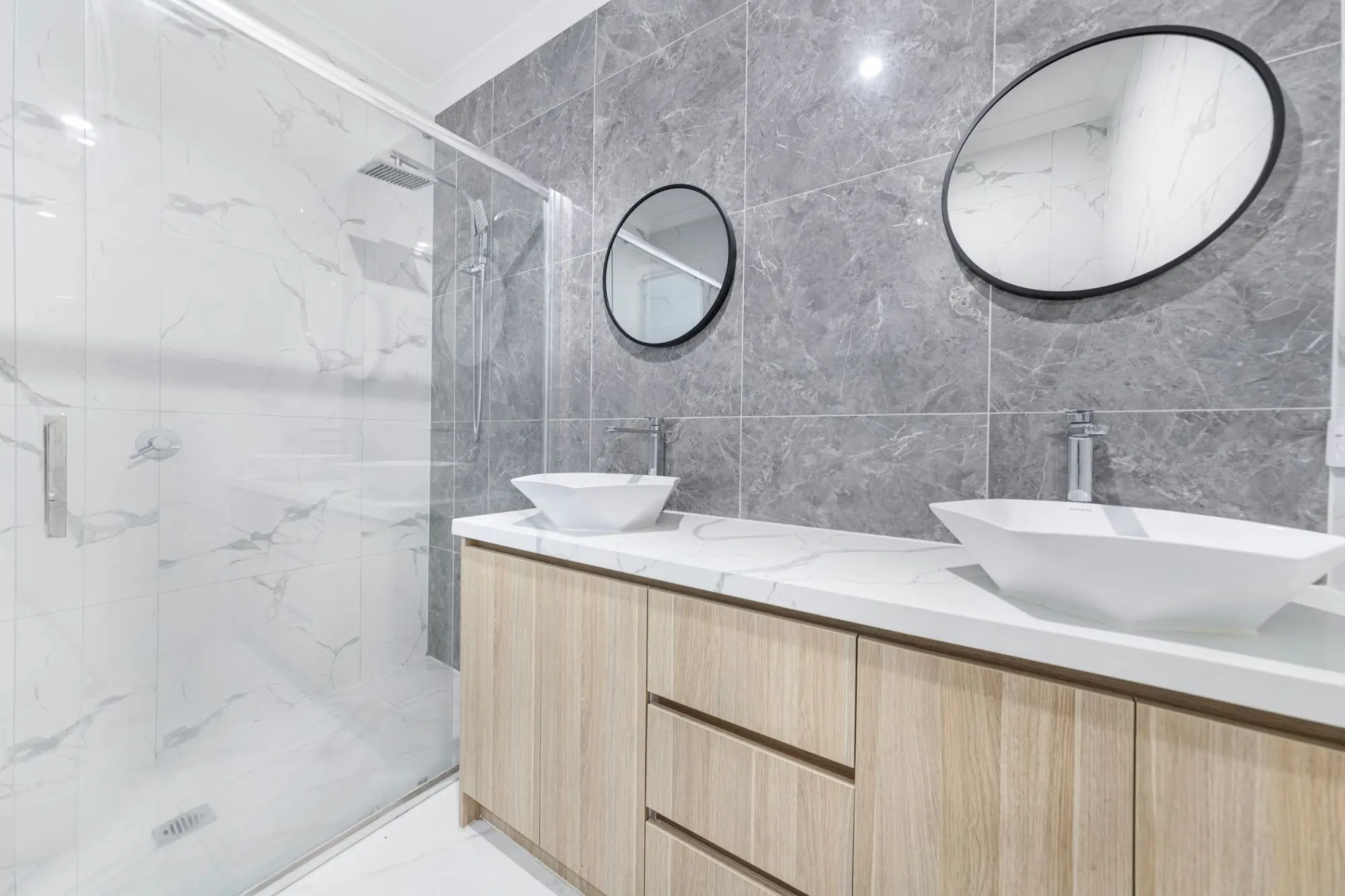 Bathroom with double sinks and an oval tub