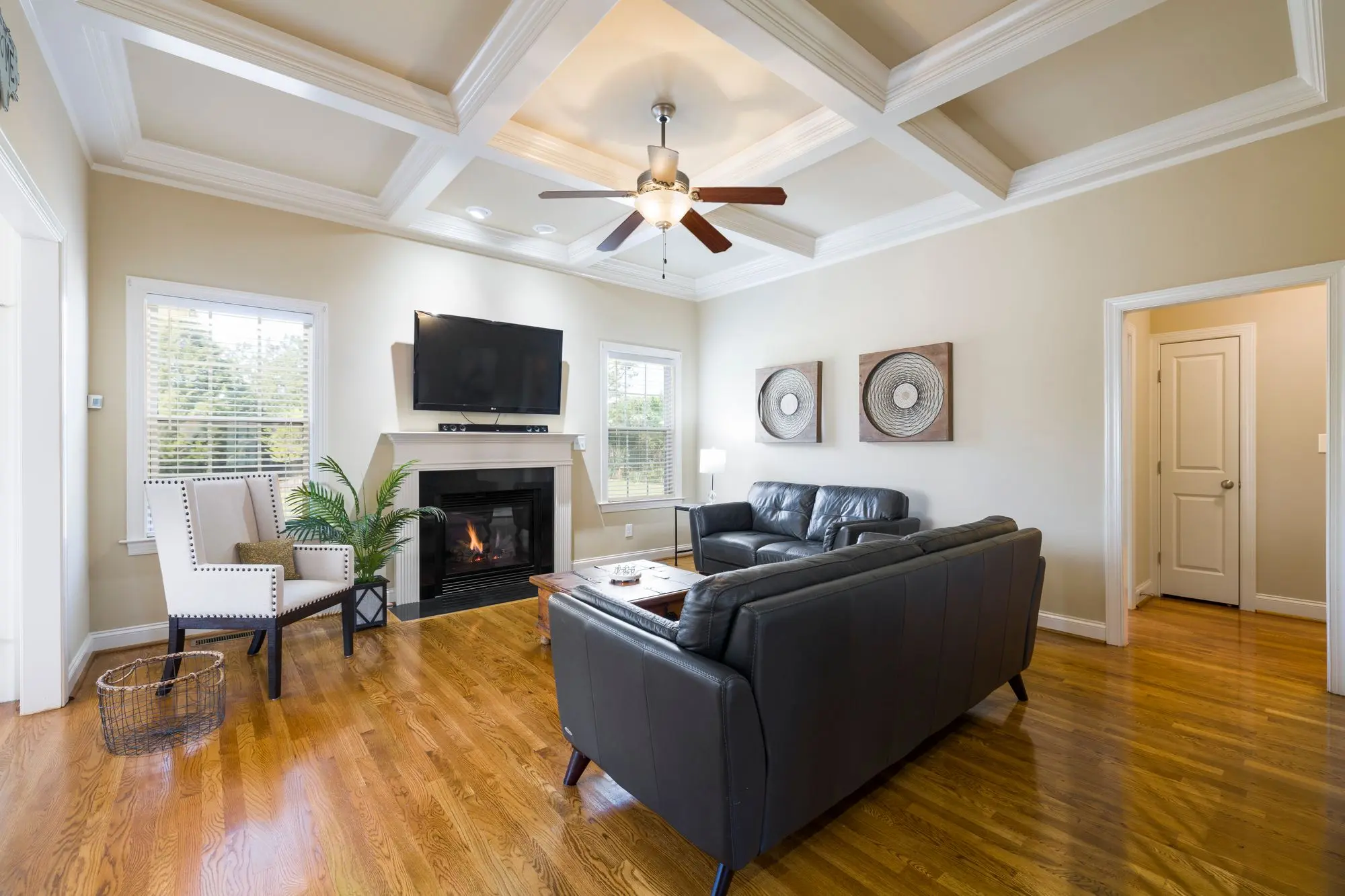 Living room with a fireplace and a tray ceiling