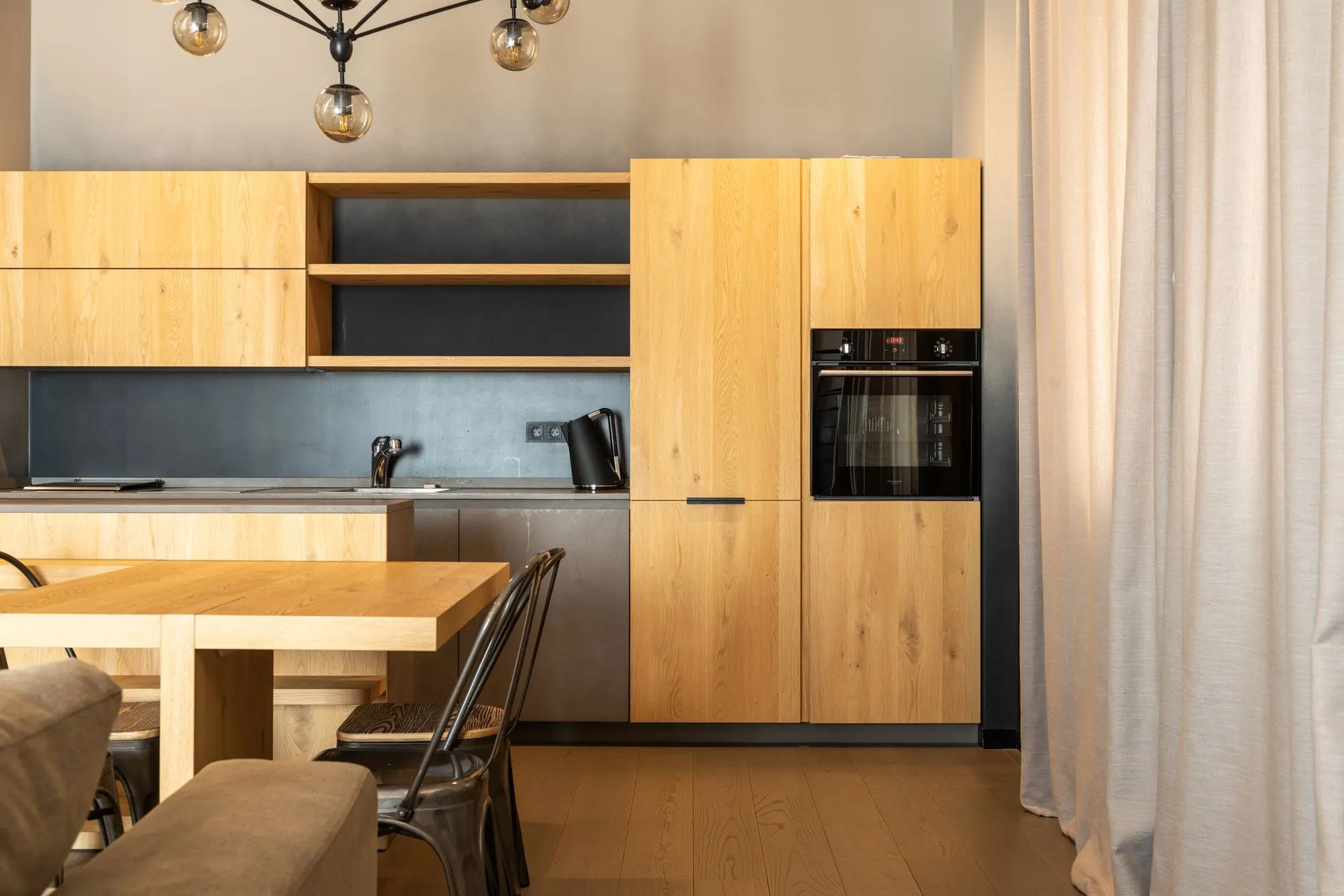Kitchen with a wooden table and chairs by the window
