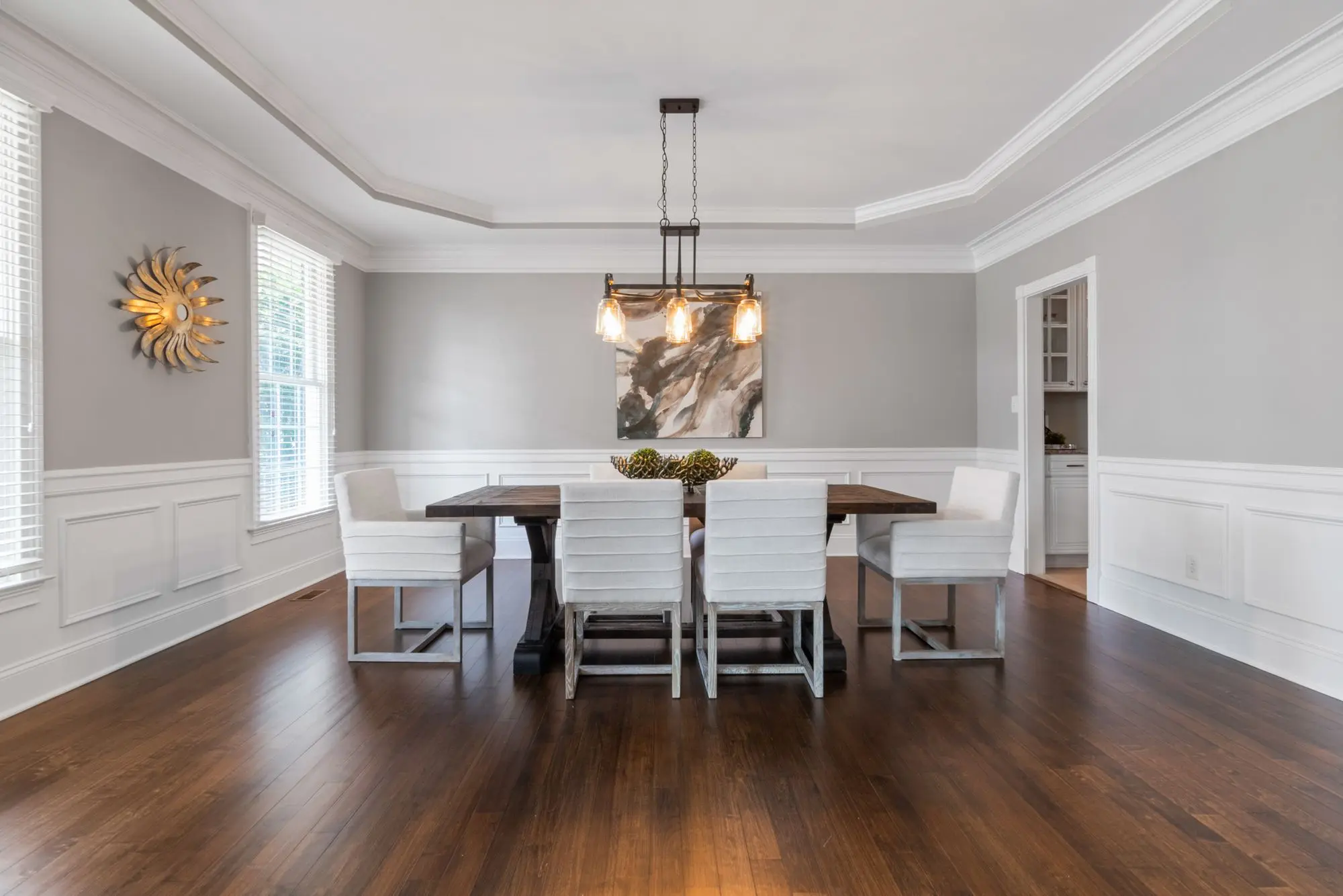 Dining room with white wainscoting and grey walls