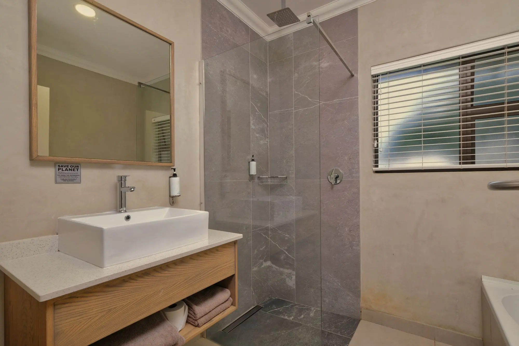 Minimal walk-in shower with a glass panel