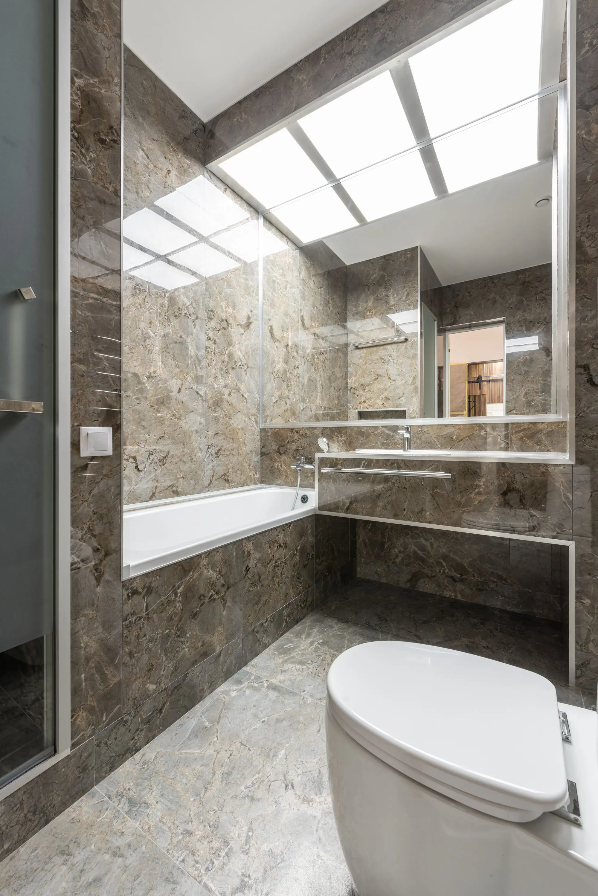 Marble tiled bathroom with a shower and vanity