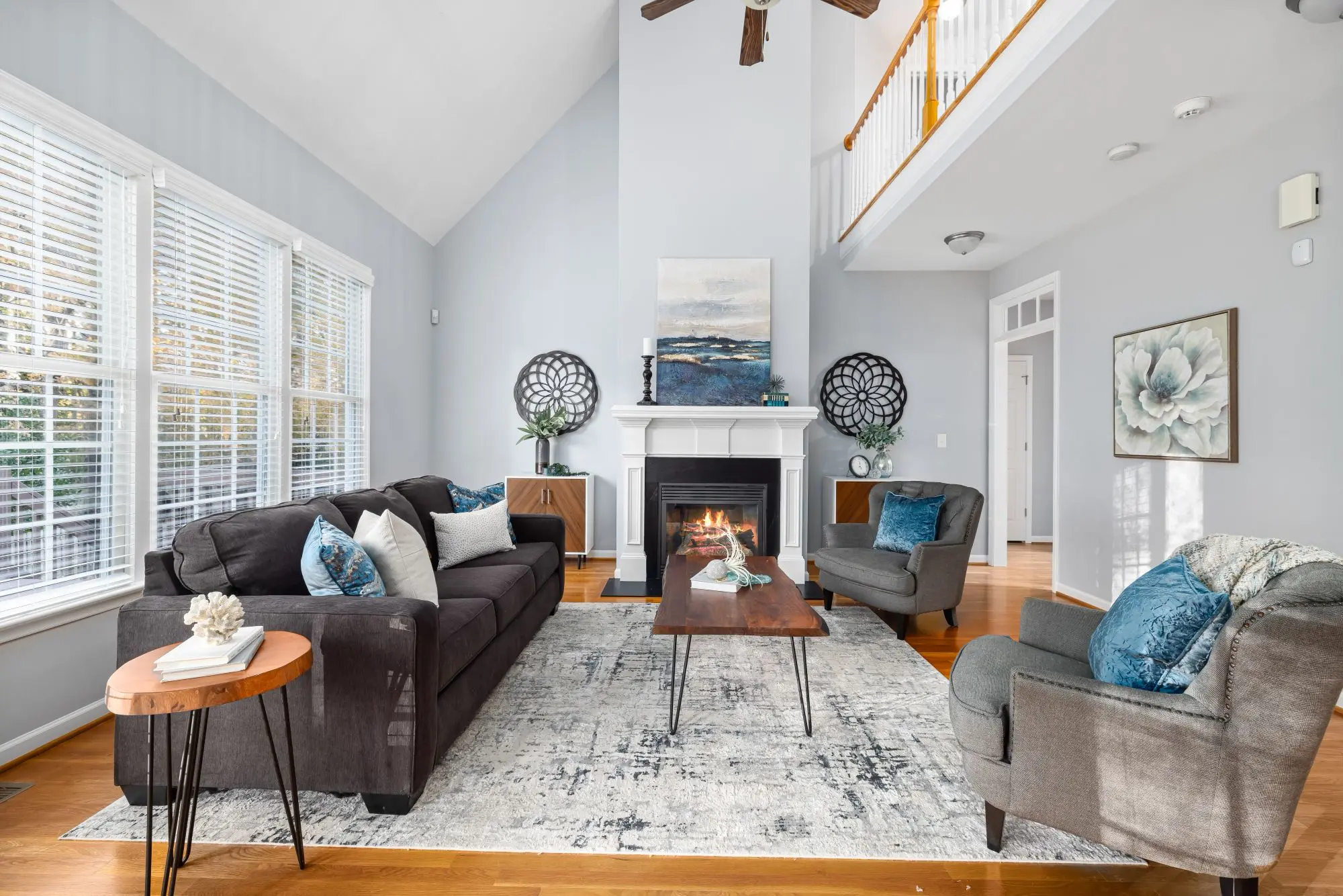Bright living room with a fireplace, sofas and hardwood floor