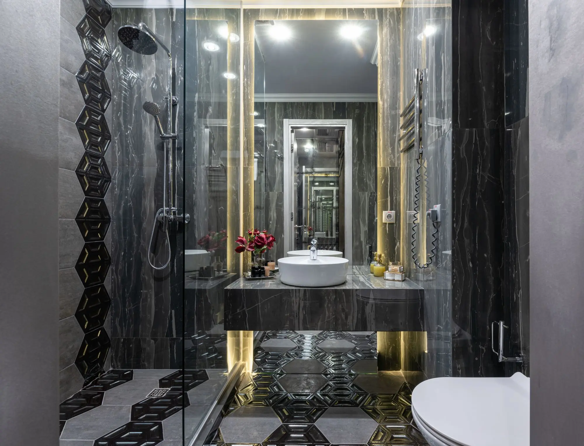 Dark stone bathroom with a walk-in shower